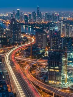 Modern city skyline with infrastructure development at dusk