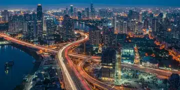 Modern city skyline with infrastructure development at dusk